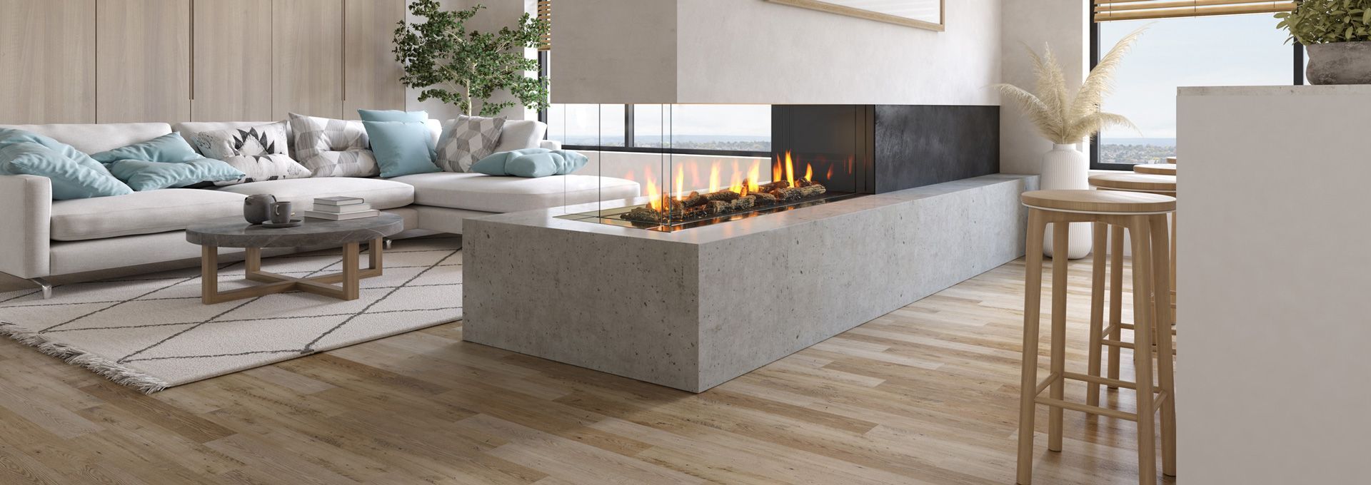 A modern living room with a white sectional sofa, a concrete fireplace with flames, and wooden floors.