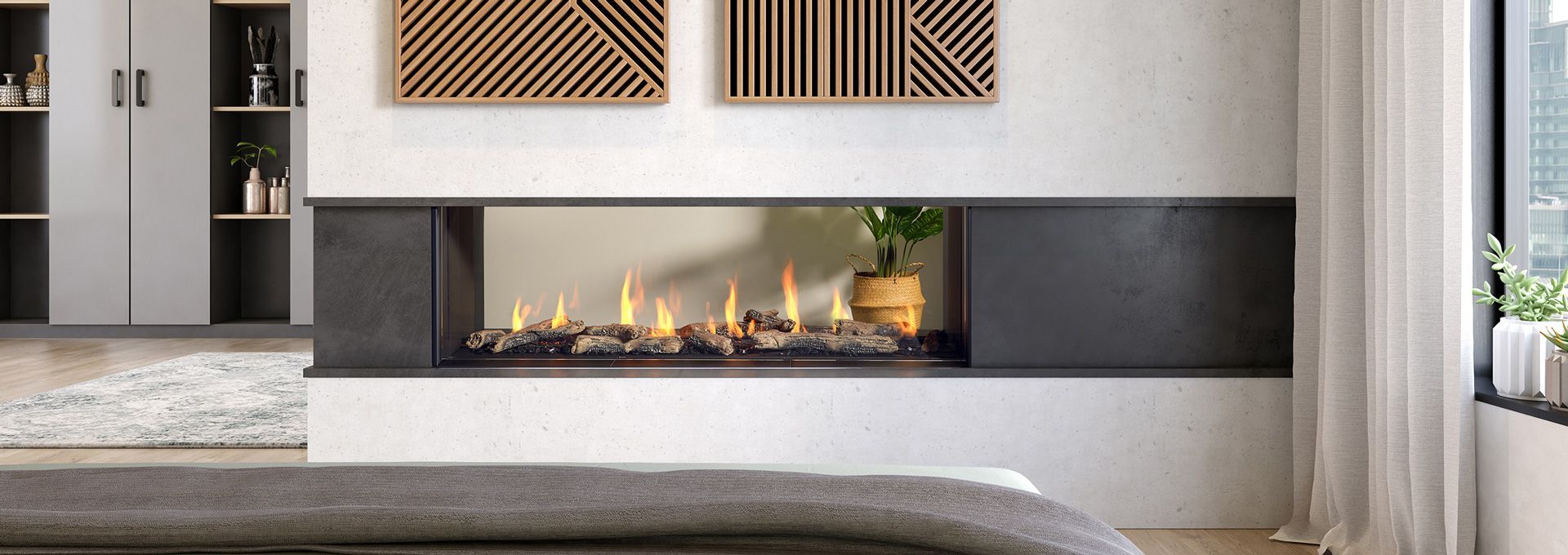 Modern fireplace with flames, surrounded by black panels, in a white-walled room. Artwork hangs above.