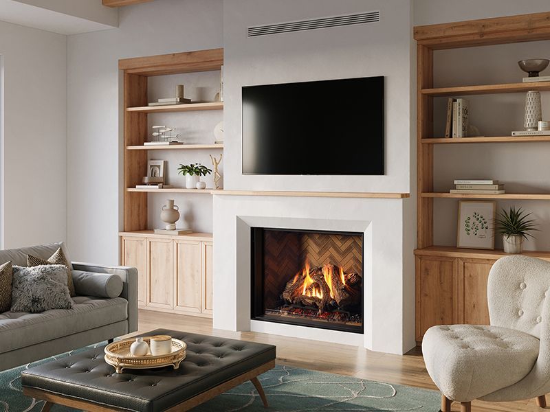 Fireplace with flames, framed in cream-colored border against grey tiled wall.  A living room with neutral colors, and wooden floor.