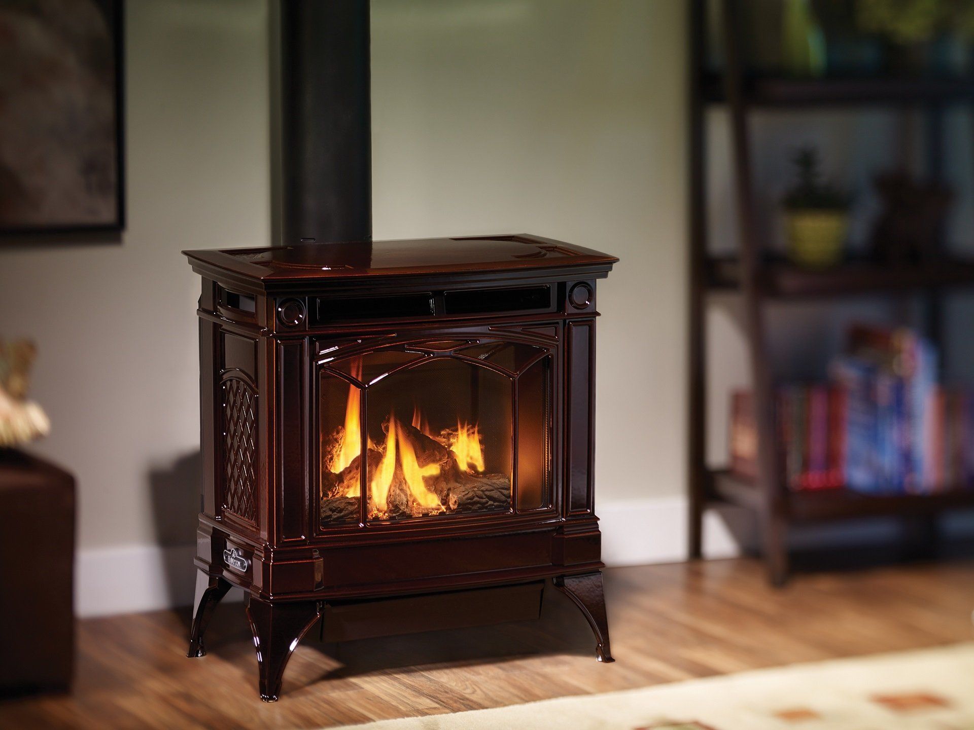 Dark brown electric fireplace with flickering flames in a living room. A black chimney rises from the top.
