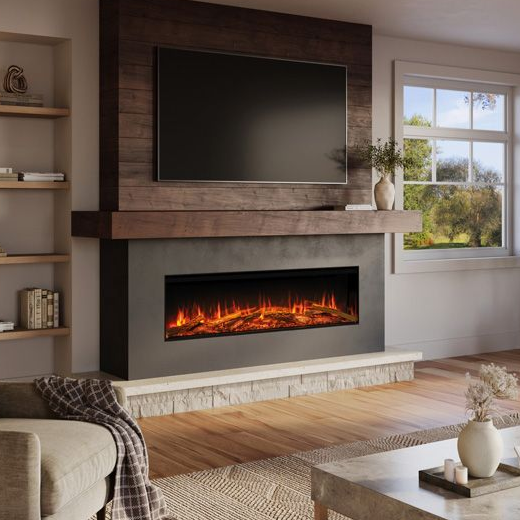 A modern fireplace with a glowing fire is set in a stone wall. A grey chaise lounge is in the foreground.