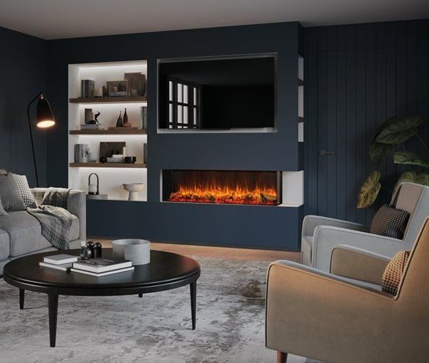 A modern living room with a dark blue accent wall featuring a fireplace, TV, and built-in shelves. A gray couch, chairs, and coffee table complete the scene.