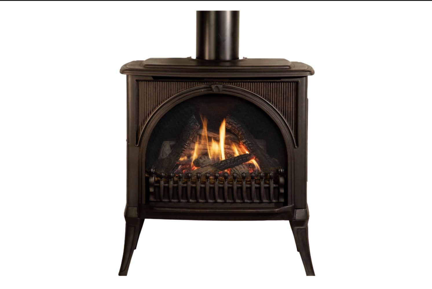 Black gas fireplace with a chimney, flames visible behind a mesh screen.