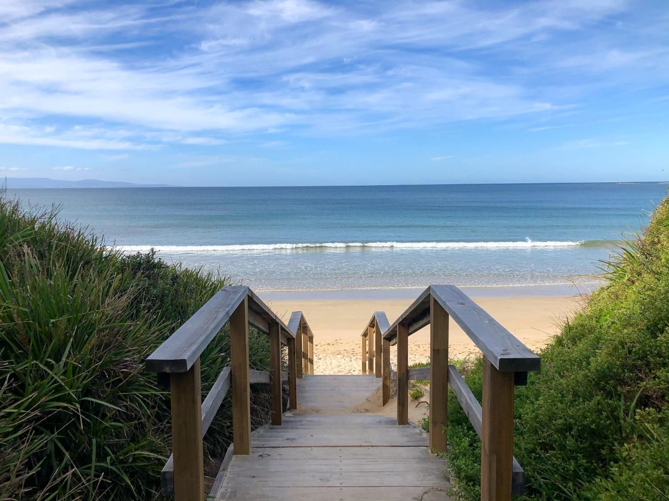 A Wooden Staircase Leading To A Beach With A View Of The Ocean — Ridgeline Building Co In South Coast, NSW