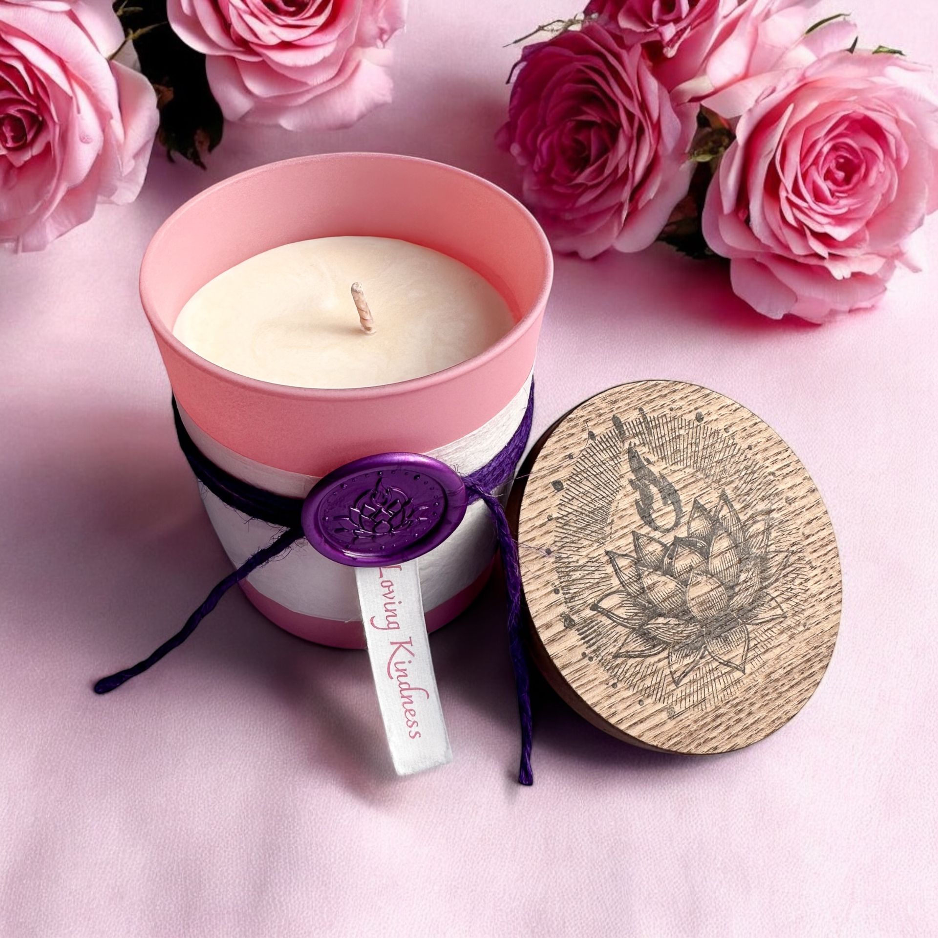 Open Loving Kindness candle by Eldara, surrounded by soft pink roses. Infused with rose quartz and sacred oils to nurture love, compassion and emotional healing.
