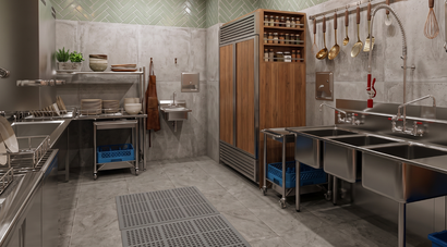 Commercial kitchen with stainless steel sinks, prep tables, hanging tools, and tiled walls