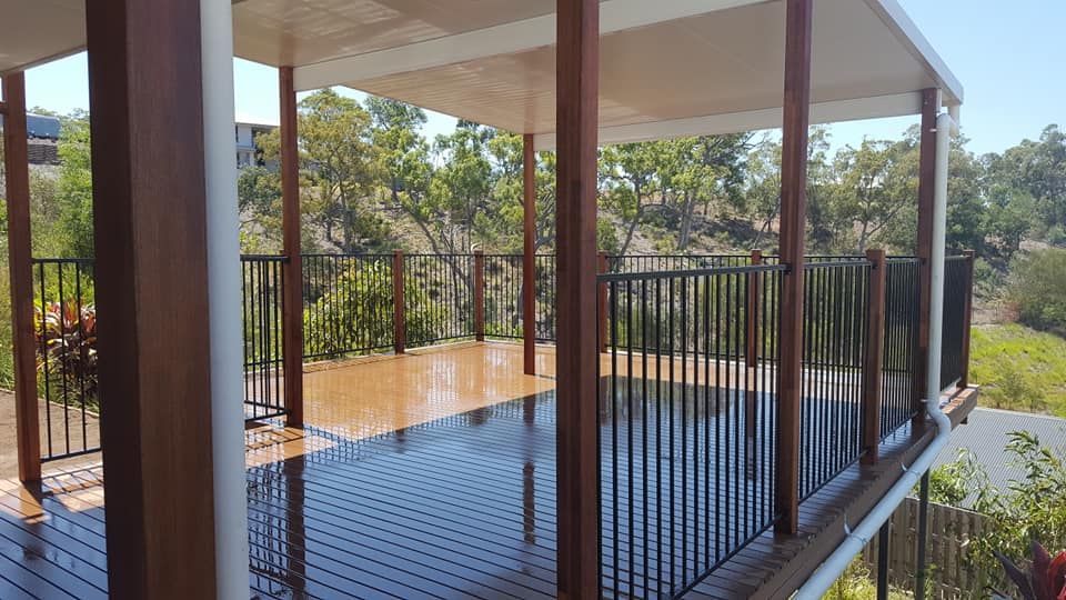 A Living Room With a Couch , Coffee Table and Fireplace — Bob Ryan's Home Improvements & Construction Pty Ltd in Beecher, QLD