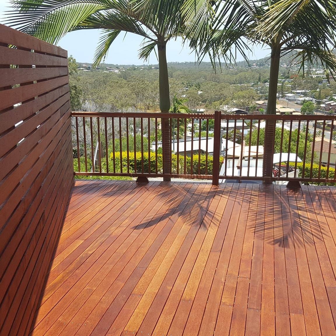 A Wooden Deck With a Wicker Couch , Chair , Table and Hammock — Bob Ryan's Home Improvements & Construction Pty Ltd in Beecher, QLD
