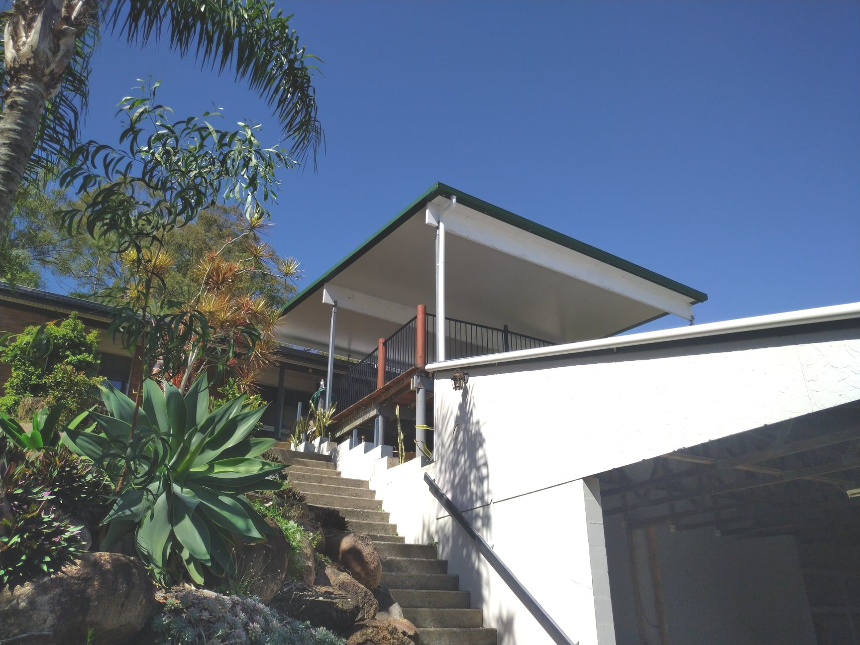 A Hallway With Hardwood Floors and a Large Mirror on the Wall — Bob Ryan's Home Improvements & Construction Pty Ltd in Beecher, QLD