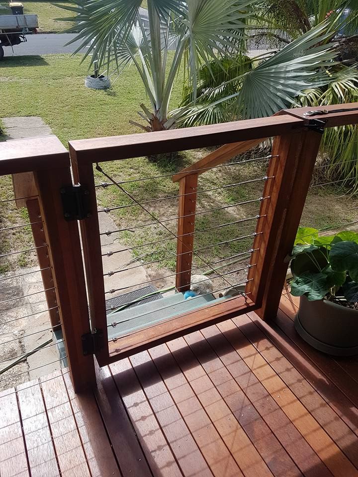 A Row of Colorful Bricks on a Sidewalk Next to a Bush — Bob Ryan's Home Improvements & Construction Pty Ltd in Beecher, QLD