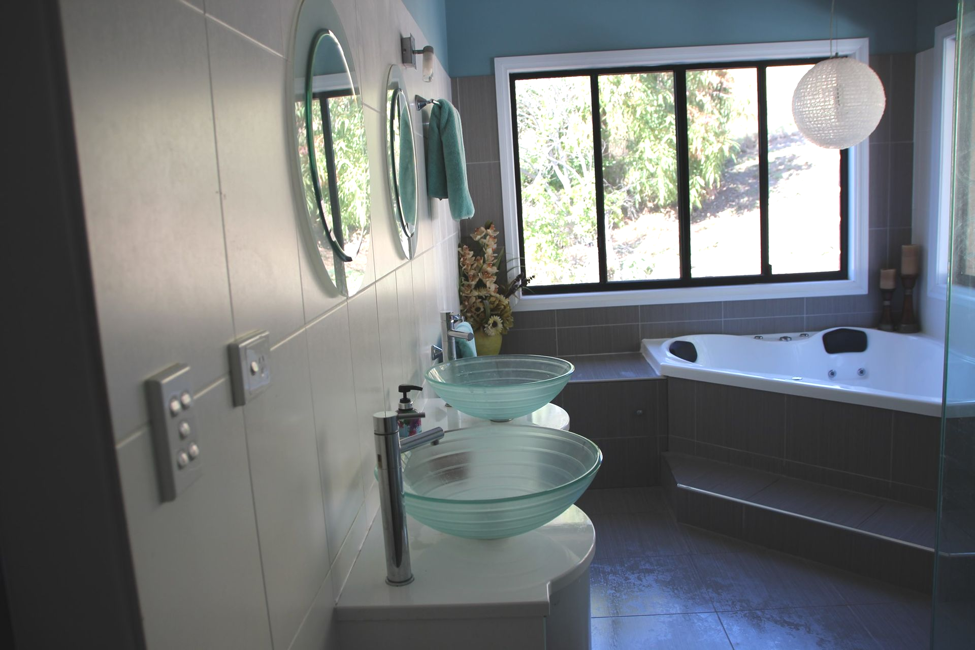 A Bathroom With a Bathtub , Toilet , Sink and Mirror — Bob Ryan's Home Improvements & Construction Pty Ltd in Beecher, QLD