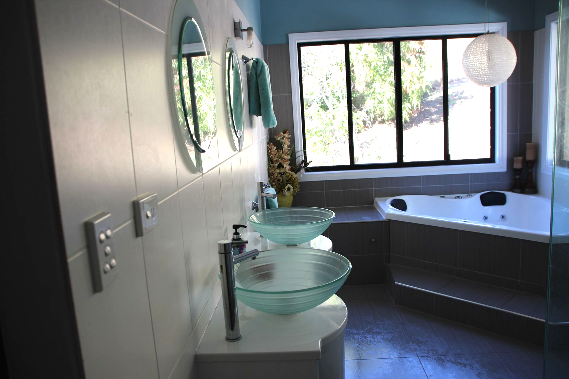 A Bathroom With a Toilet , Sink and Mirror — Bob Ryan's Home Improvements & Construction Pty Ltd in Beecher, QLD