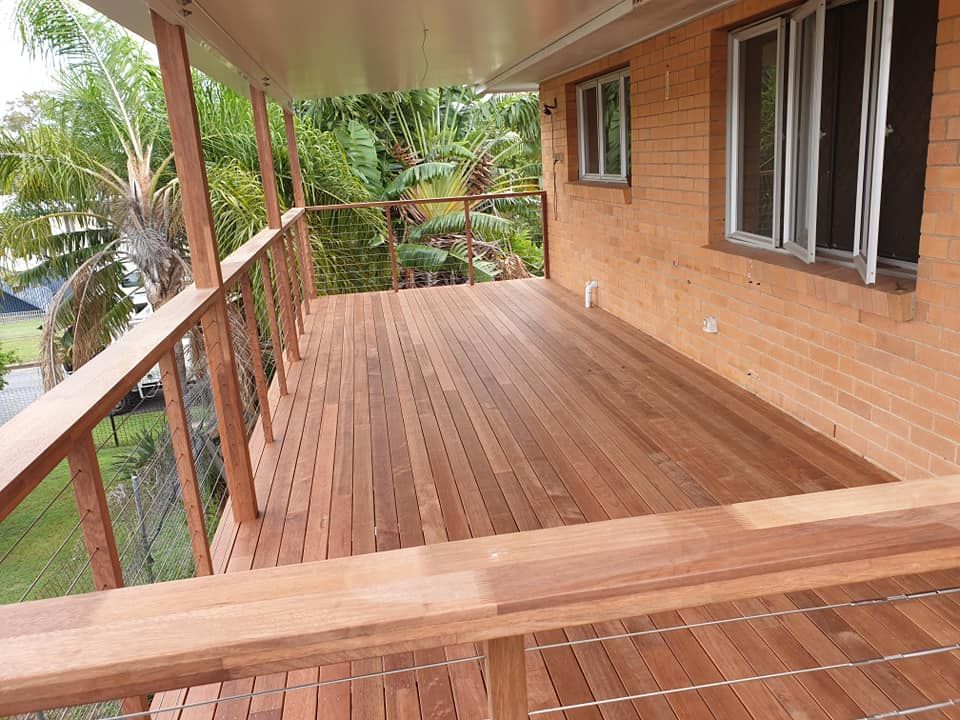 A Wooden Deck Next to a Swimming Pool — Bob Ryan's Home Improvements & Construction Pty Ltd in Beecher, QLD