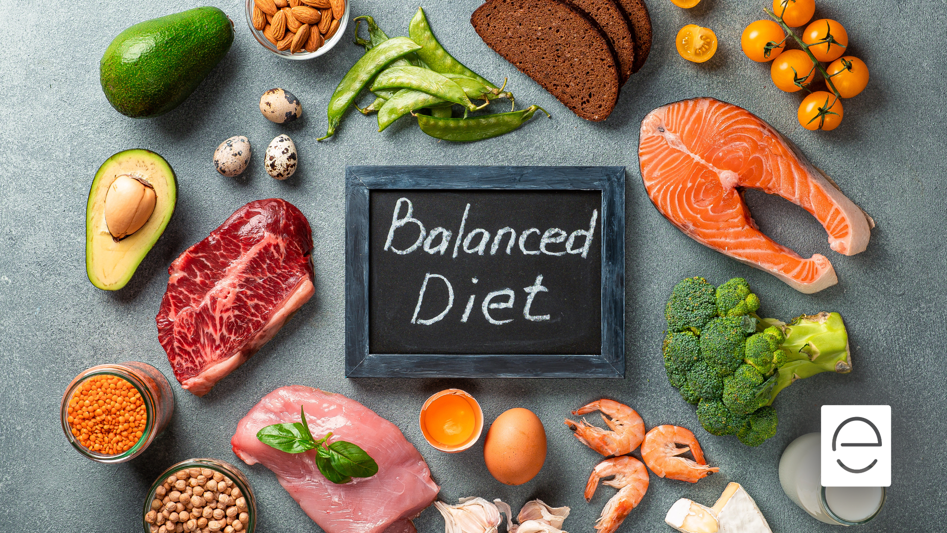 Various foods arranged around a chalkboard with 