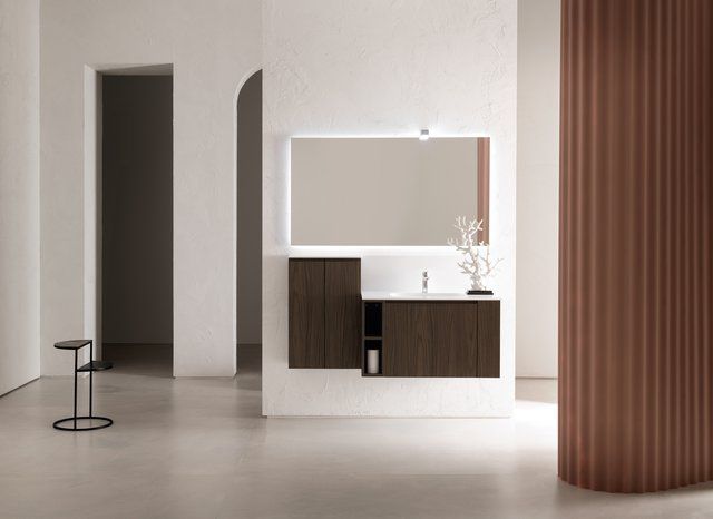 Un bagno con lavandino, specchio e armadietti