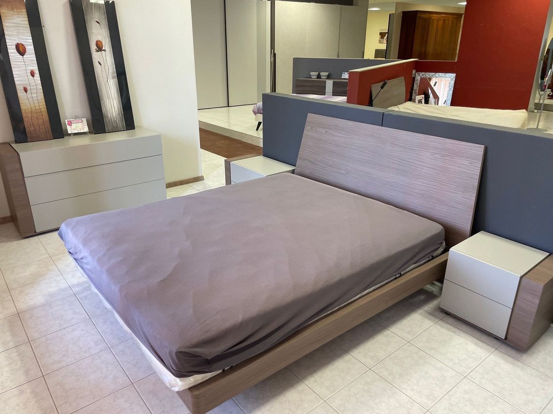 Una camera da letto con un letto e due comodini