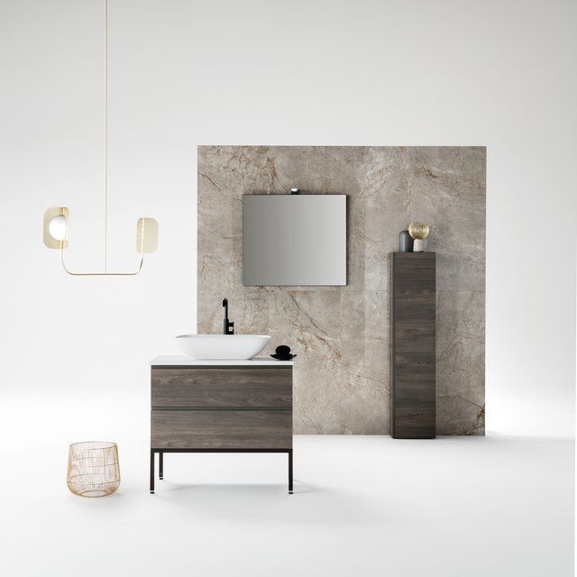 Un bagno con un lavandino e uno specchio sul muro