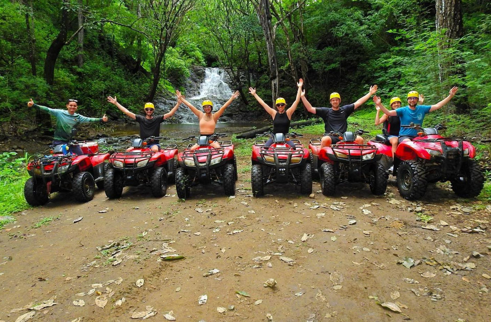 ATV adventure tour in Guanacaste Costa Rica with a group exploring tropical trails and nature near a waterfall