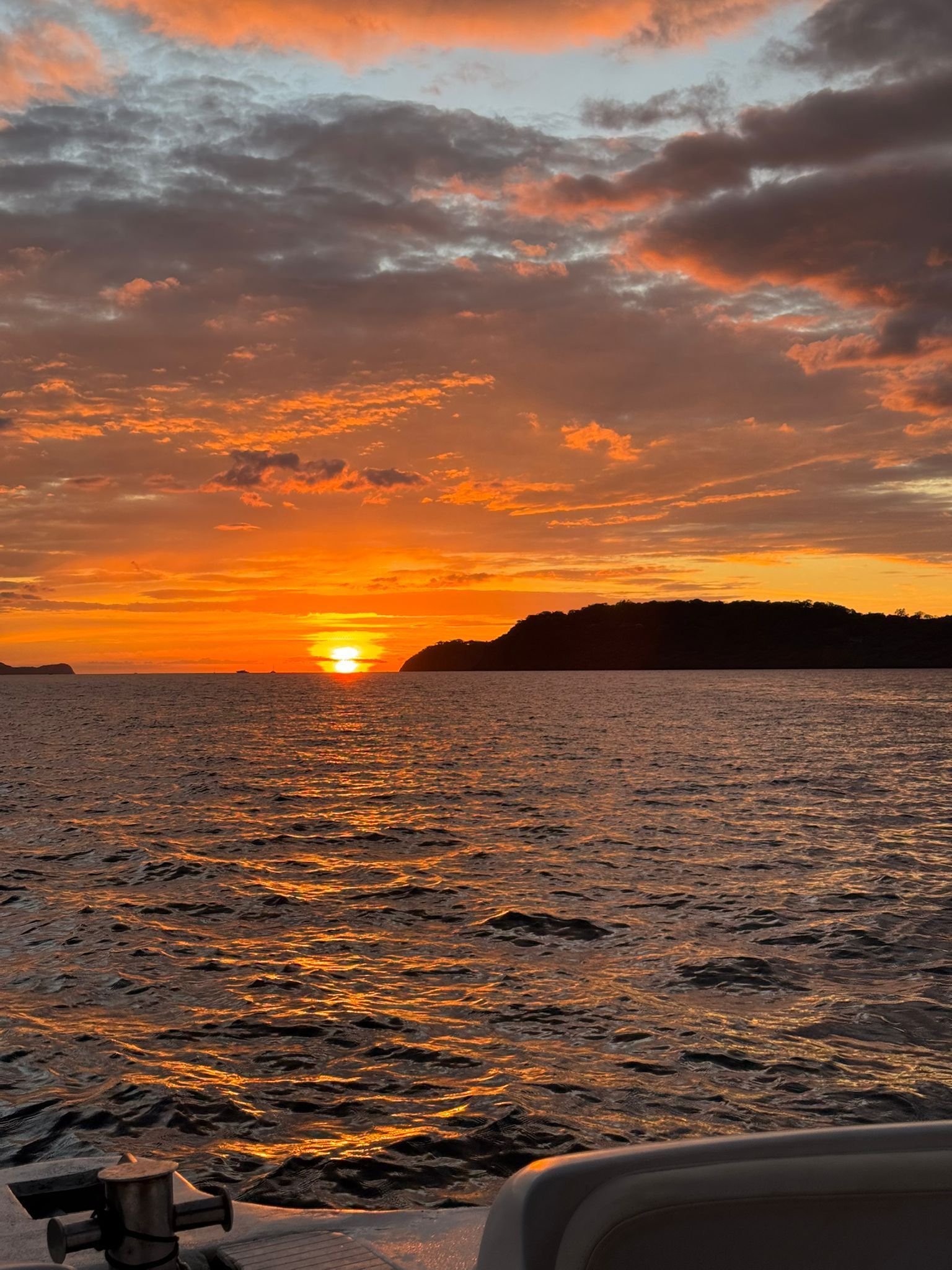 Pacific Ocean sunset during a private boat tour in Guanacaste Costa Rica surrounded by beautiful coastal scenery