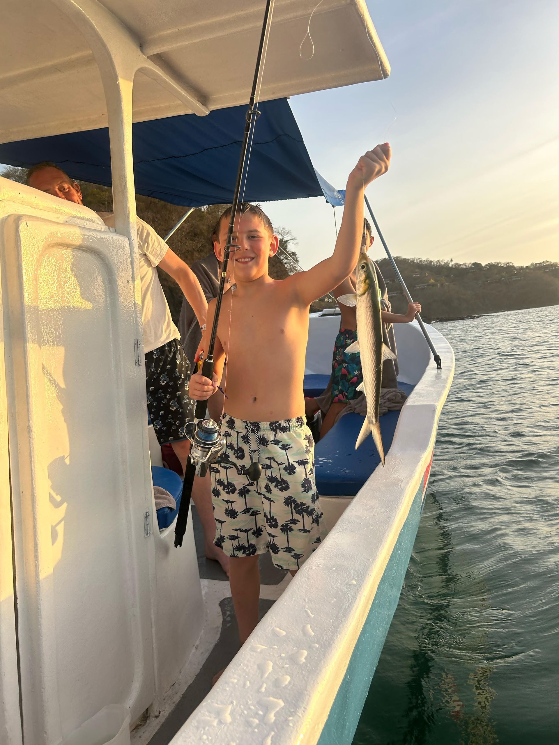 Young angler enjoying a family private fishing charter with his catch in Guanacaste, Costa Rica.