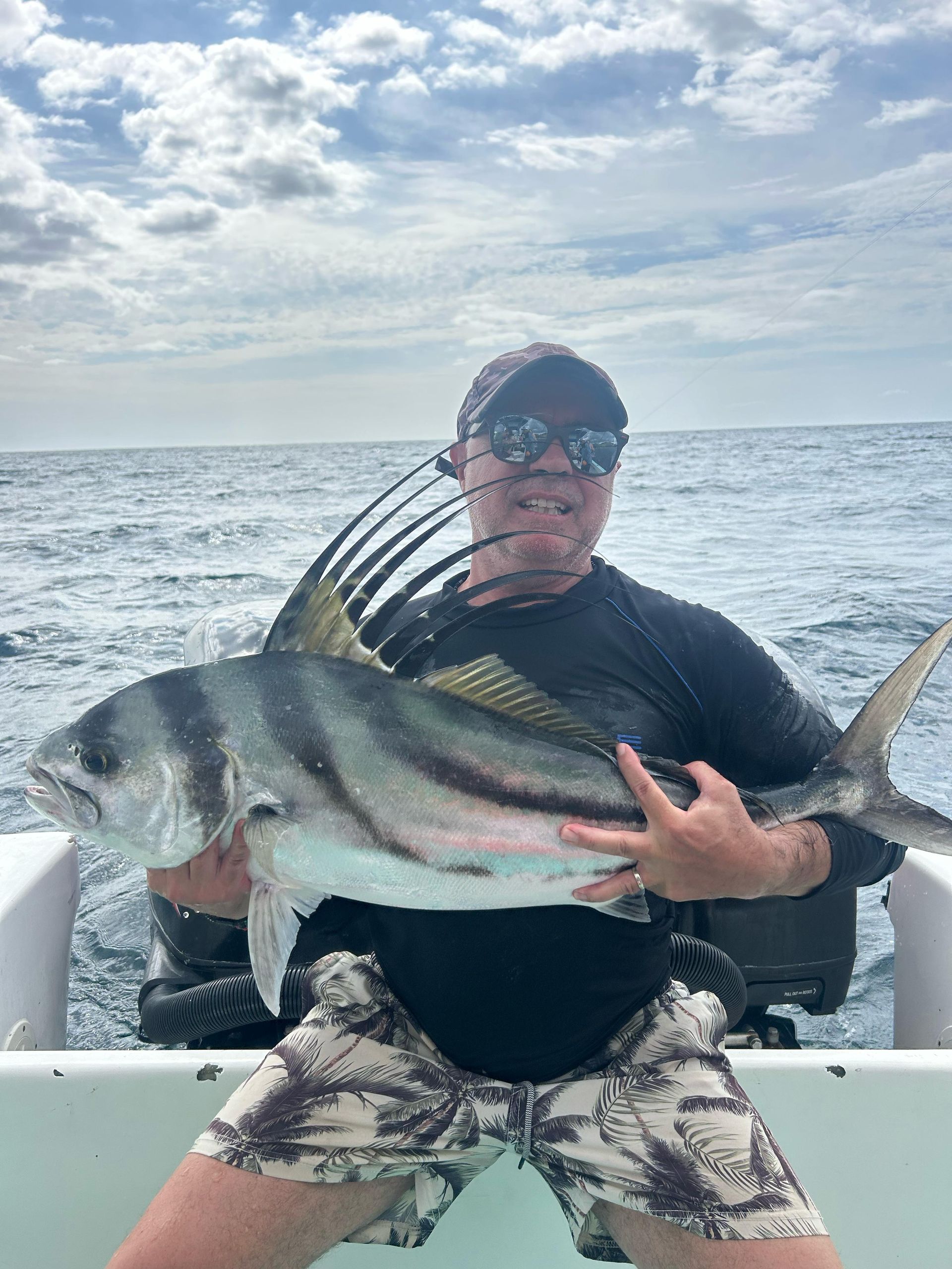 Angler holding a roosterfish caught during a private fishing charter in Guanacaste, Costa Rica on the Pacific coast.