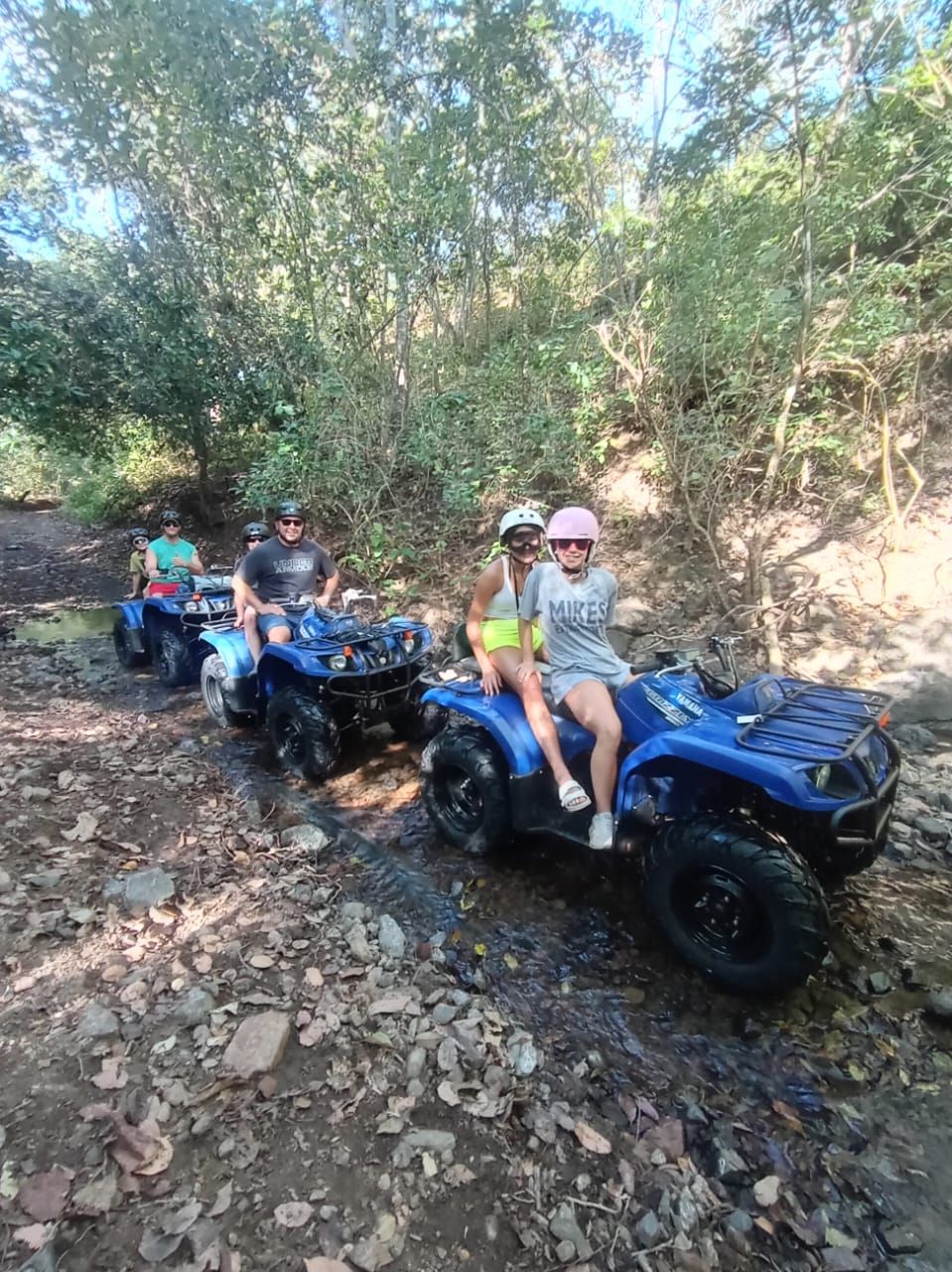ATV adventure tour in Guanacaste Costa Rica with a group exploring tropical trails and nature near a waterfall