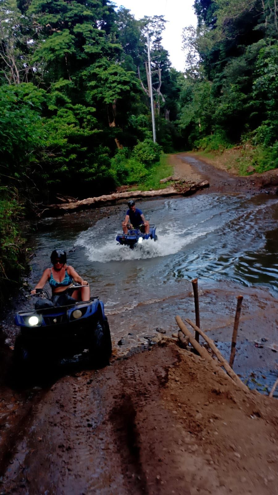 ATV excursion in Guanacaste Costa Rica riding through a water crossing and rugged tropical off-road adventure trail