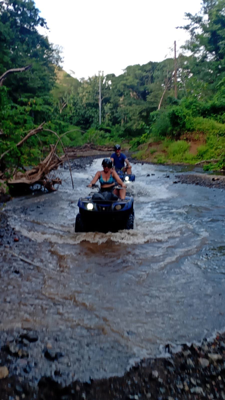 ATV tour in Guanacaste Costa Rica crossing water on tropical off-road trails during an exciting adventure excursion