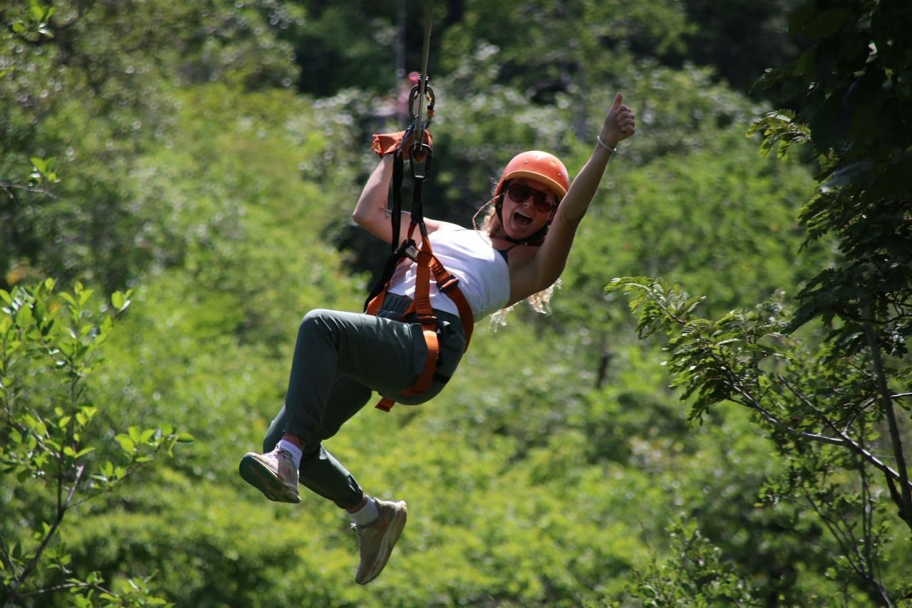 Mega Combo tour in Guanacaste Costa Rica with traveler ziplining above tropical terrain during an adventure excursion
