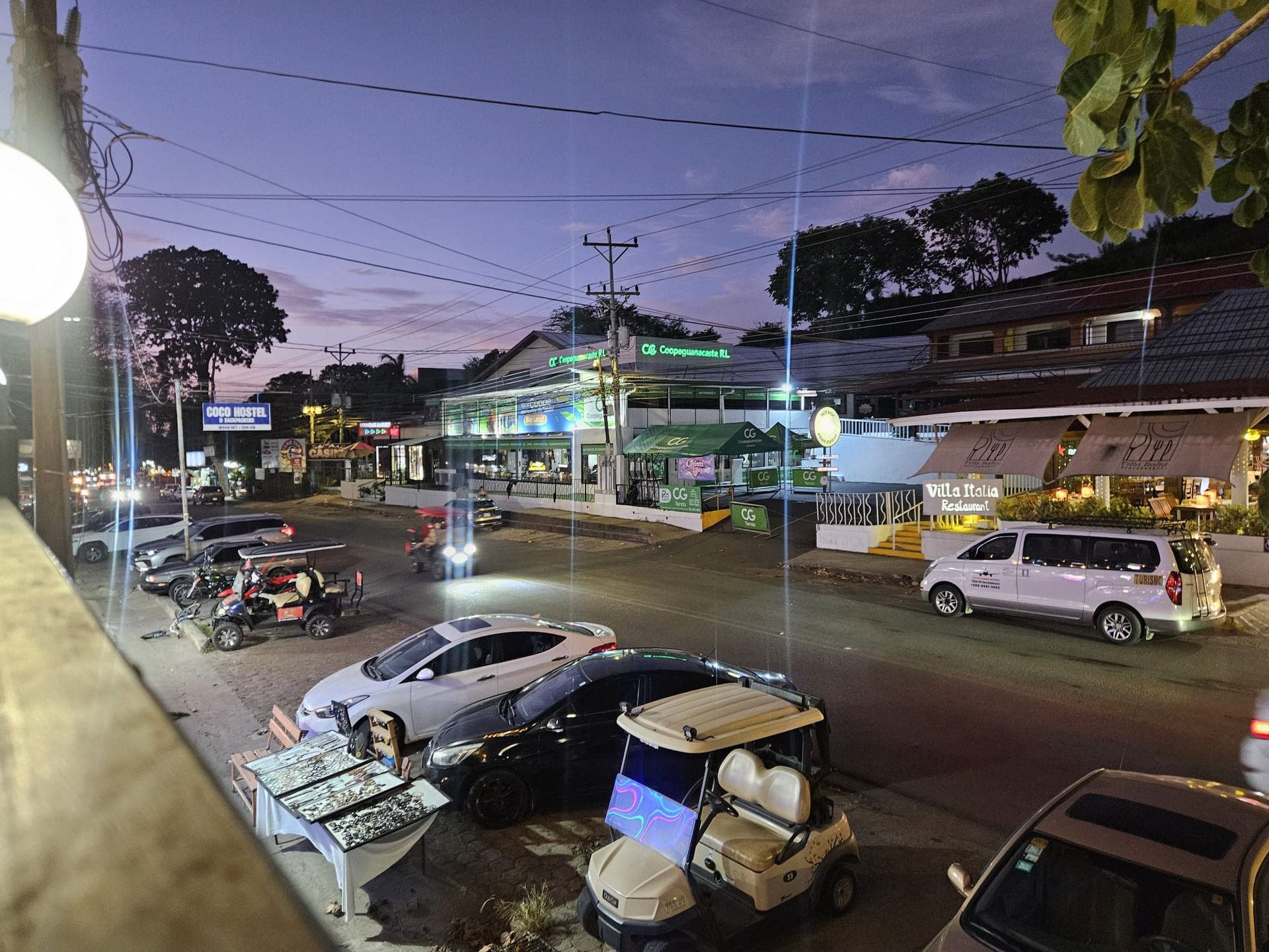 Downtown Playas del Coco at night with restaurants, shops and local street activity in Costa Rica.