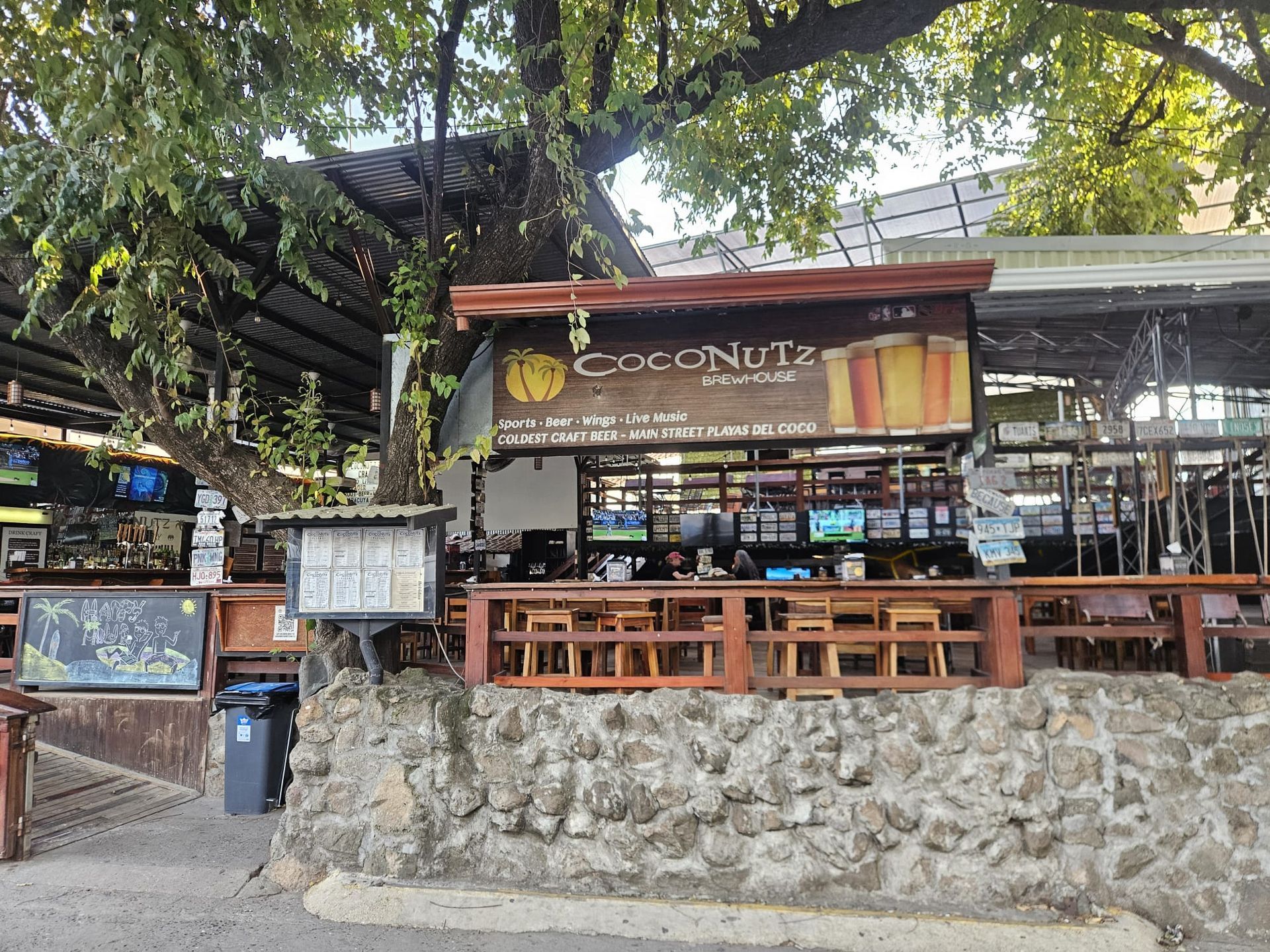 Local open-air restaurant surrounded by tropical trees in Playas del Coco Guanacaste Costa Rica.