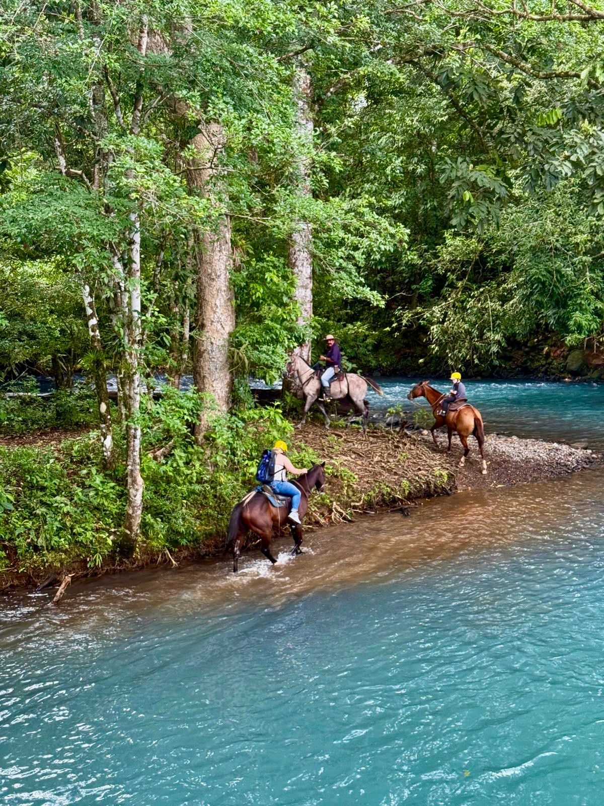 Horseback riding near Tenorio River Costa Rica through tropical rainforest and beautiful natural river landscapes