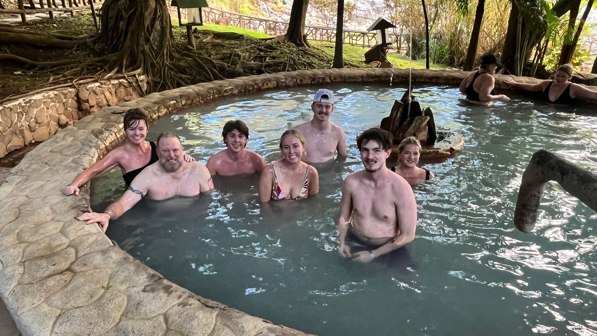 Visitors relaxing in natural hot springs at Miravalles Volcano during a private Costa Rica excursion.