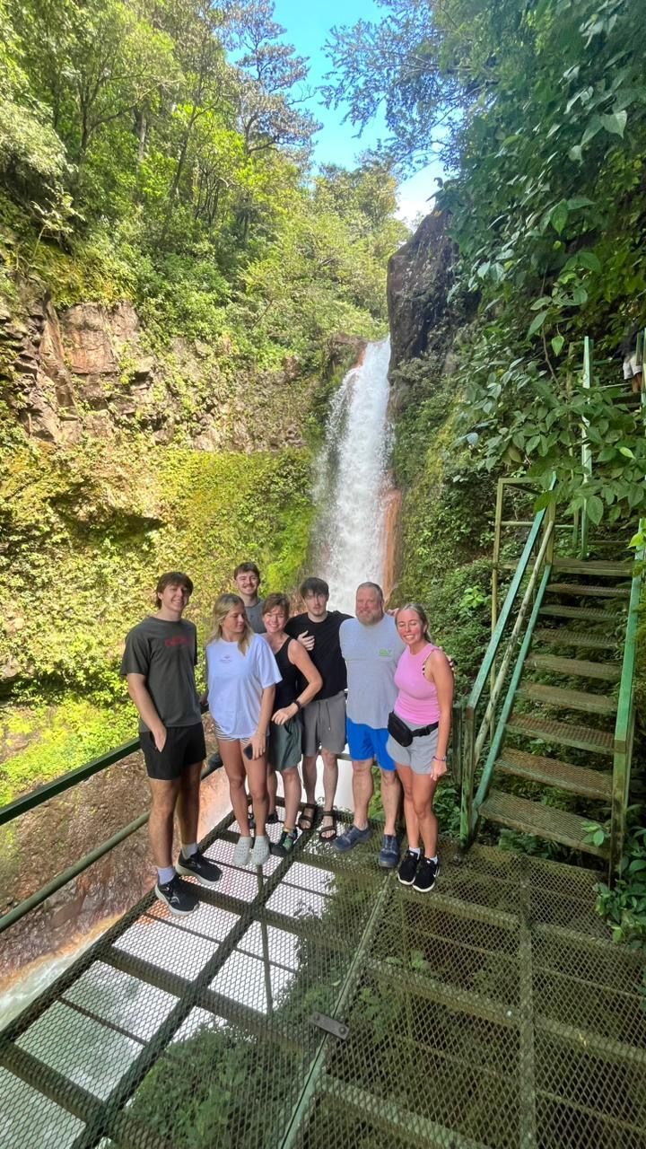 Private tour guests visiting a beautiful waterfall near Miravalles Volcano in Guanacaste, Costa Rica.