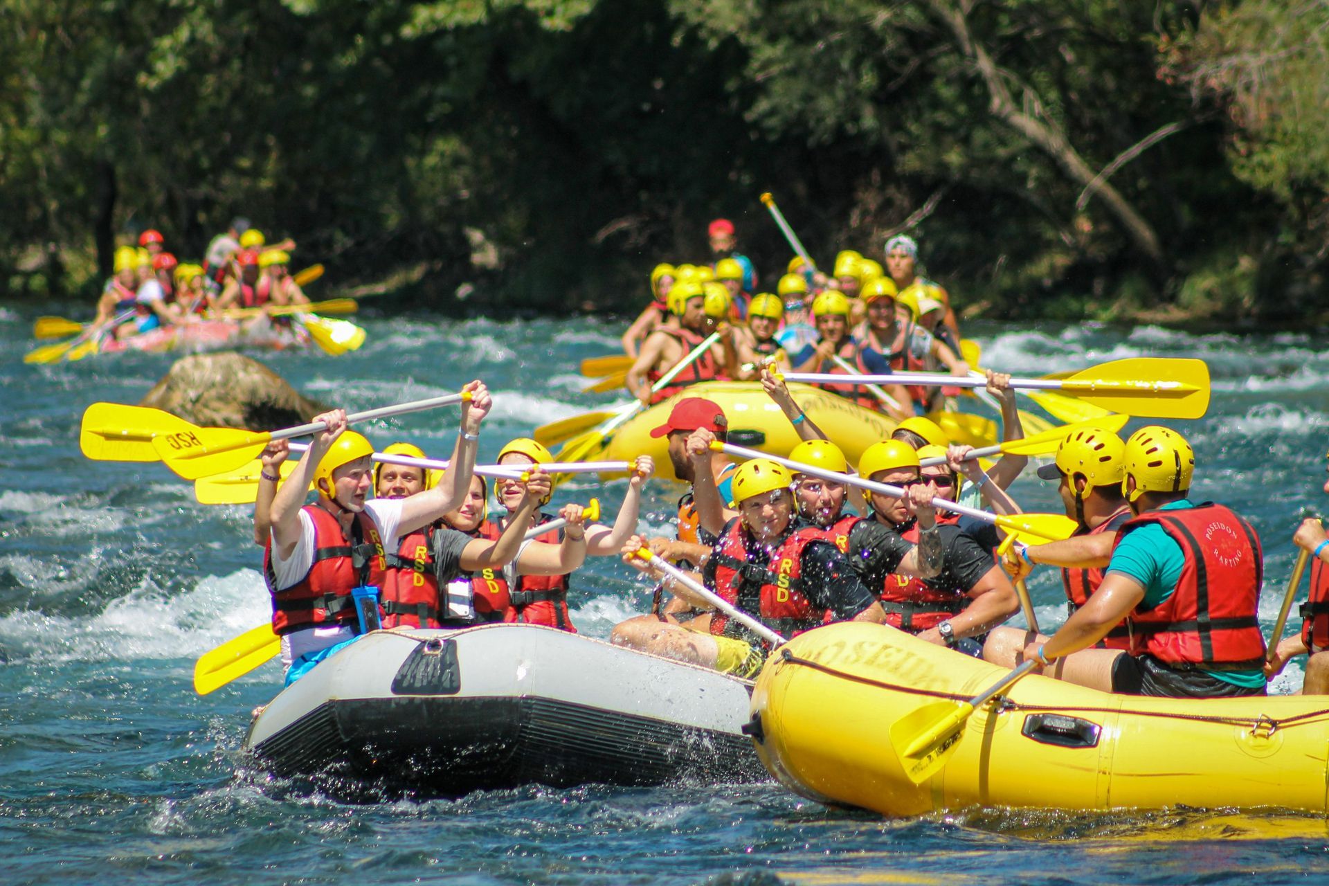 Travelers enjoying a white water rafting excursion in Costa Rica surrounded by tropical scenery and exciting river adventure
