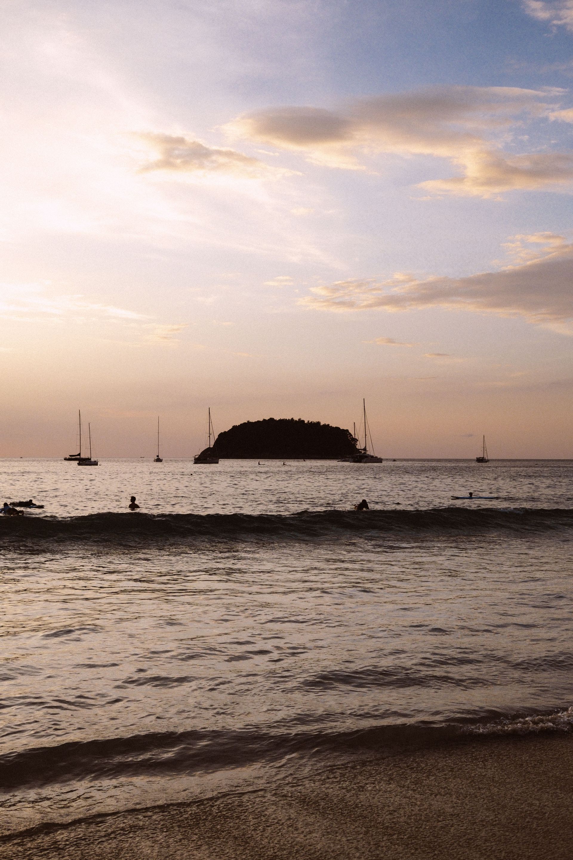 Playas del Coco Costa Rica sunset over the Pacific Ocean with boats, gateway to private excursions 