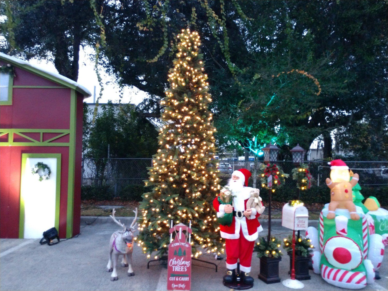 outdoor santa on sleigh with huge stack of gifts pulled by a raindeer