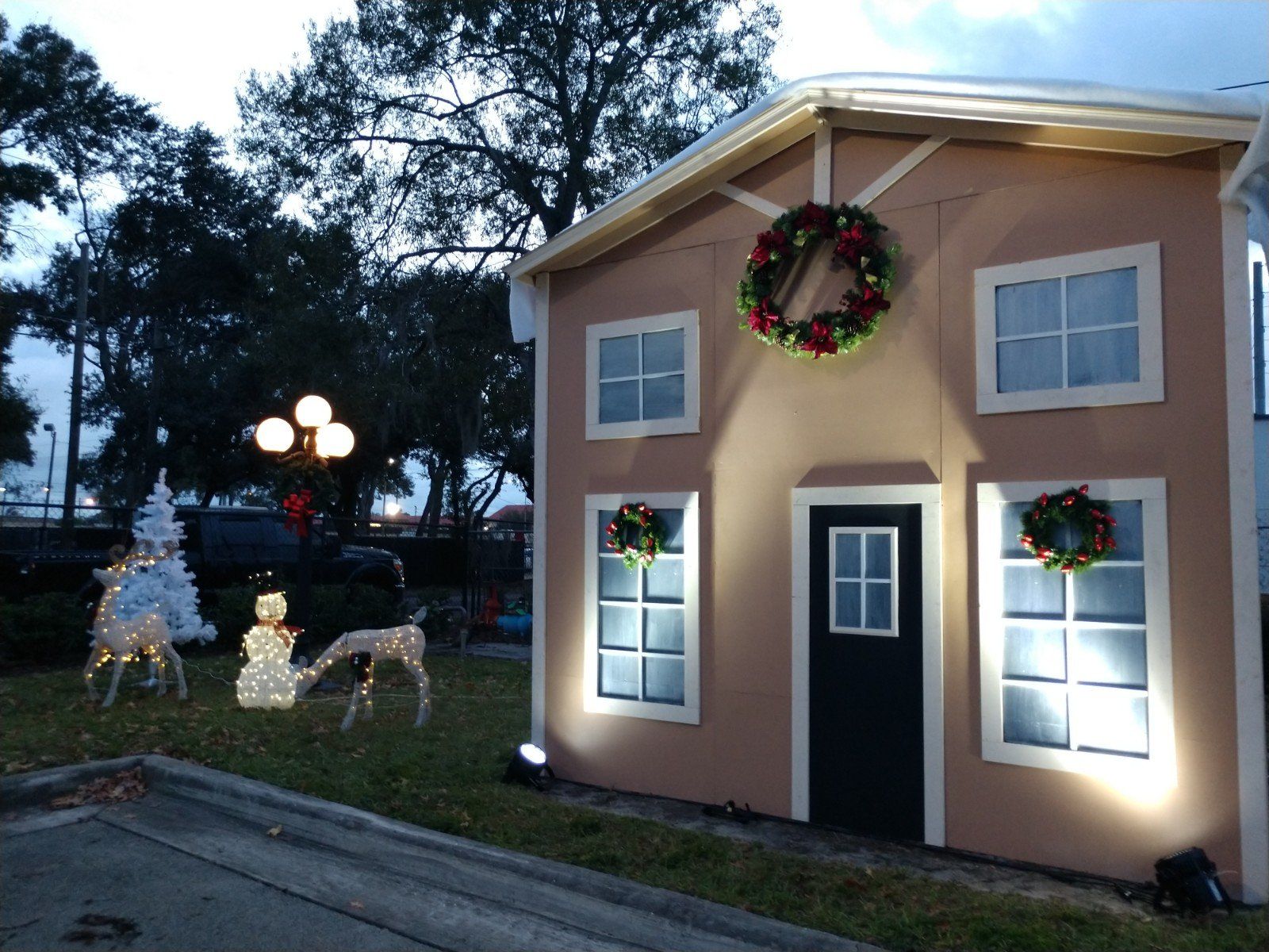 tan Christmas display house with raindeer