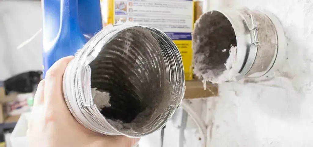 A person is holding a dirty duct in their hand.