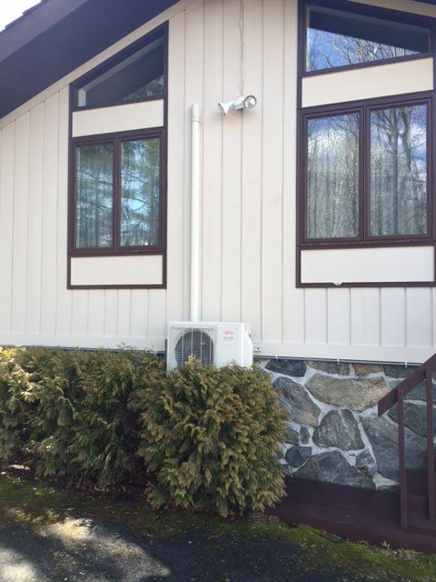 Technician Servicing Heating Boiler - Heating Services in Jericho, VT Technician Servicing Heating Boiler - Heating Services in Jericho, VT