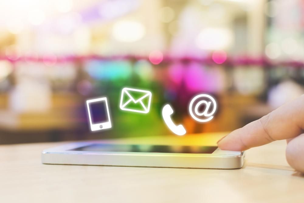 A Person is Using a Smart Phone With Contact Icons Coming Out of It — Gem Socials In South West Rocks, NSW