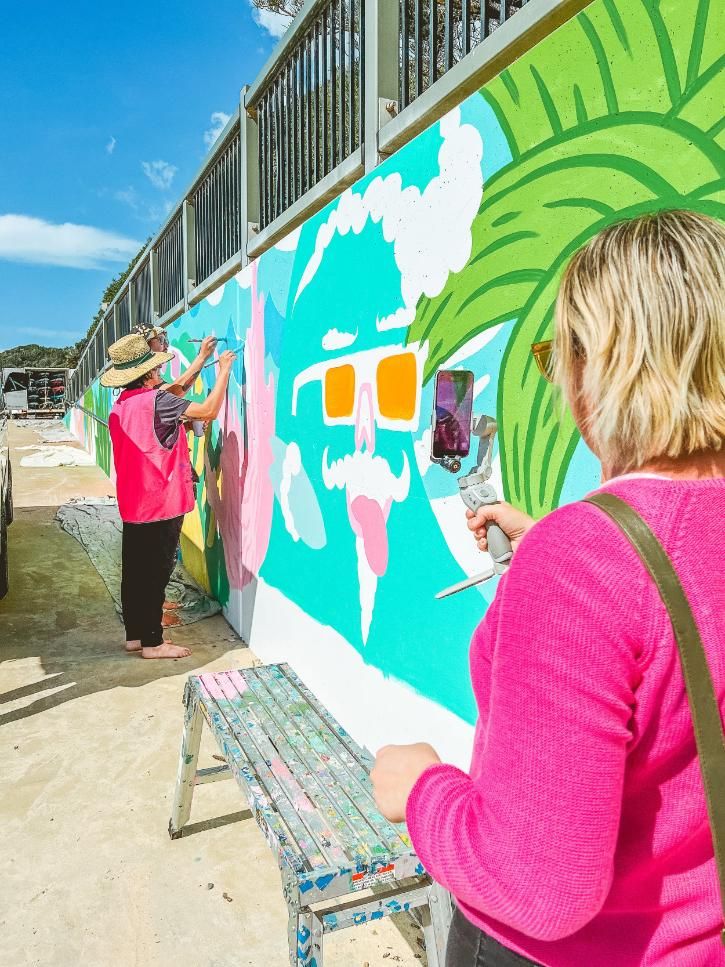 Two People Are Painting a Mural on a Wall — Gem Socials In Port Macquarie, NSW