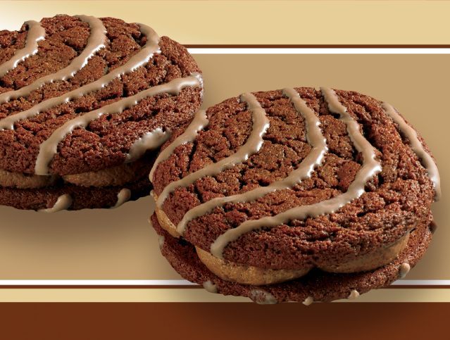 image of two fudge round cookies on a brown background