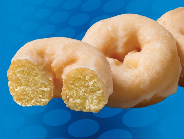 a glazed mini donut with a bite taken out of it