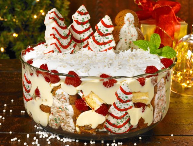 A trifle with a gingerbread man on top of it