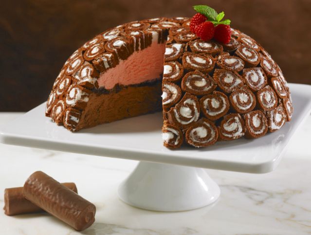 A chocolate dome cake with a strawberry on top