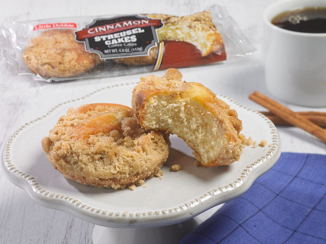 two single serve cinnamon streusel cakes with one missing a bite next to a wrapped one