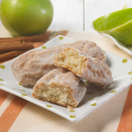 two apple cinnamon donut sticks on a dotted plate