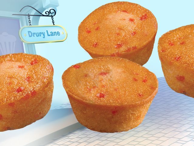 Four cupcakes on a table with a sign that says drury lane
