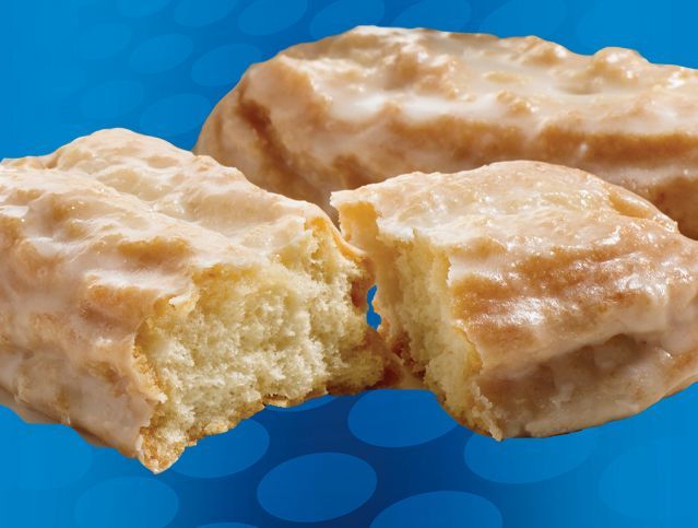 A glazed donut with a bite taken out of it